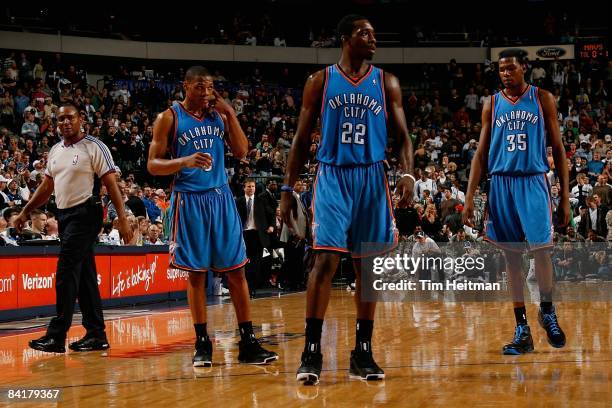 Russell Westbrook, Jeff Green and Kevin Durant of the Oklahoma City Thunder walk across the court during the game against the Dallas Mavericks on...