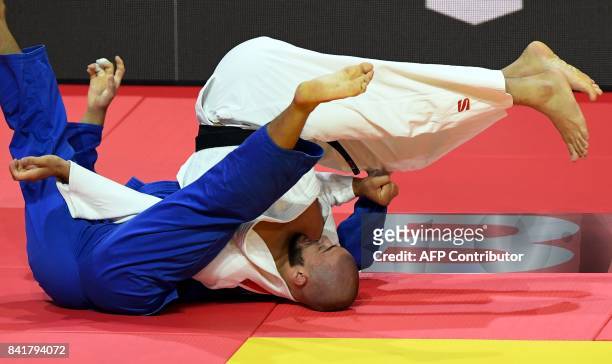 Russia's Kazbek Zankishiev competes with Japan's Ryunosuke Haga during their match in the mens -100kg category at the World Judo Championships in...
