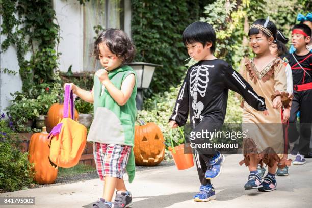 children marching in front of the house wearing costumes. - princess pirates stock pictures, royalty-free photos & images