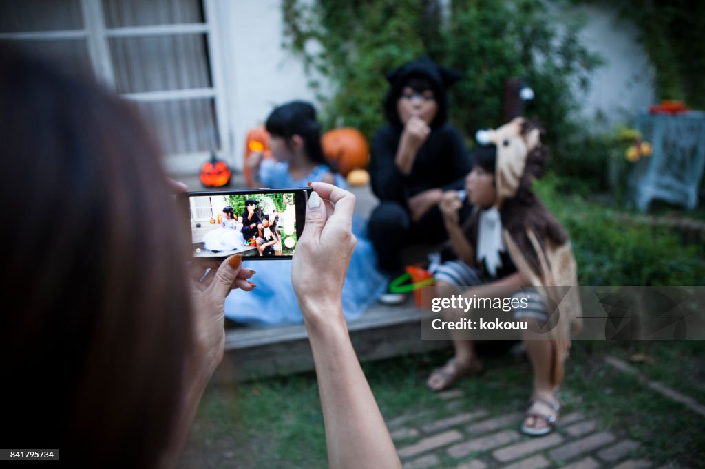 The mother takes pictures of the children.