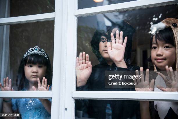 children's looks into the outside from the window. - boy tiara stock pictures, royalty-free photos & images