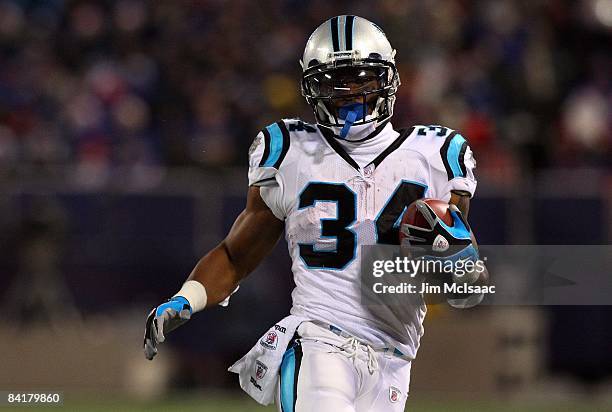 DeAngelo Williams of the Carolina Panthers runs the ball against the New York Giants on December 21, 2008 at Giants Stadium in East Rutherford, New...