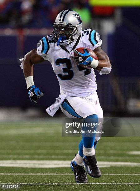 DeAngelo Williams of the Carolina Panthers runs the ball against the New York Giants on December 21, 2008 at Giants Stadium in East Rutherford, New...