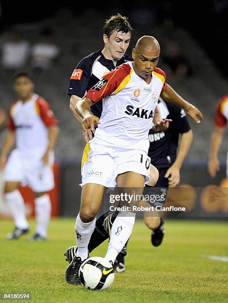 Cristiano of United is pressured by Sebastian Ryall of the Victory during the round 15 A-League match between the Melbourne Victory and Adelaide...