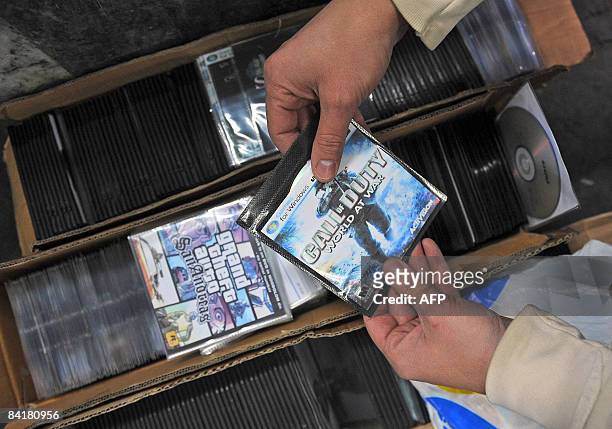 Street vendor displays the newest illegally produced video games and movies on December 30, 2008 in downtown Belgrade. Hundreds of thousands of...