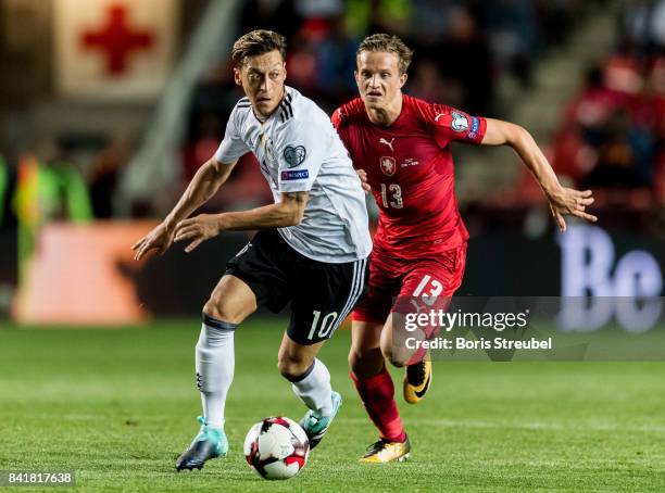 Mesut Oezil of Germany is challenged by Jan Kopic of Czech Republic during the FIFA 2018 World Cup Qualifier between Czech Republic and Germany at...