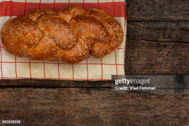 shabbat or sabbath kiddush ceremony composition with a traditional sweet fresh loaf of challah bread on a vintage wood background with copy space"n - kiddush cup fotografías e imágenes de stock