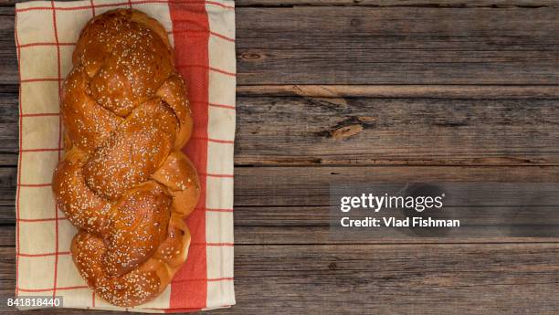 shabbat or sabbath kiddush ceremony composition with a traditional sweet fresh loaf of challah bread on a vintage wood background with copy space"n - challah stock pictures, royalty-free photos & images