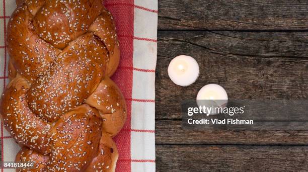 shabbat or sabbath kiddush ceremony composition with a traditional sweet fresh loaf of challah bread on a vintage wood background with copy space"n - kiddush cup stockfoto's en -beelden