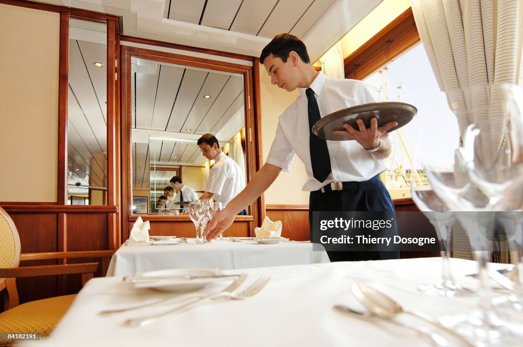 Waiter laying the table