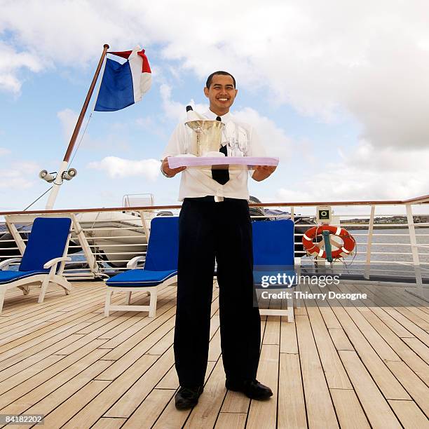 waiter holding tray with champagne and glasses - aboard stock pictures, royalty-free photos & images