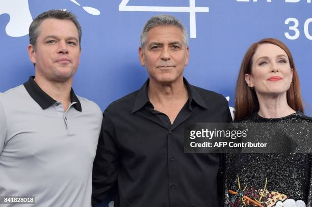 Actor Matt Damon , US actor and director George Clooney and US actess Julianne Moore attend the photocall of the movie "Suburbicon" presented out of...