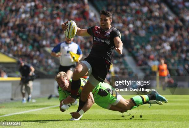 Sean Maitland of Saracens evades Harry Mallinder of Northampton Saints to score their fifth try during the Aviva Premiership match between Saracens...