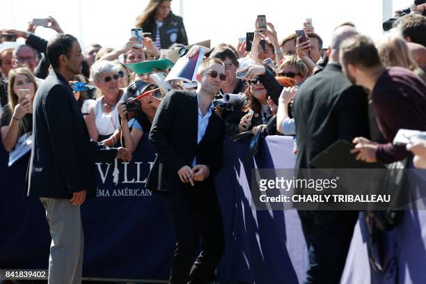 British actor Robert Pattinson poses with fans for selfie photos, within the inauguration of his dedicated beach locker room on the Promenade des...