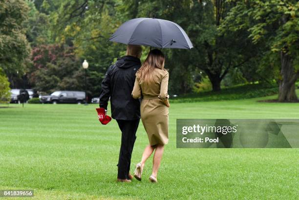 President Donald Trump walks with first lady Melania Trump prior to their Marine One departure from the White House September 2, 2017 in Washington,...