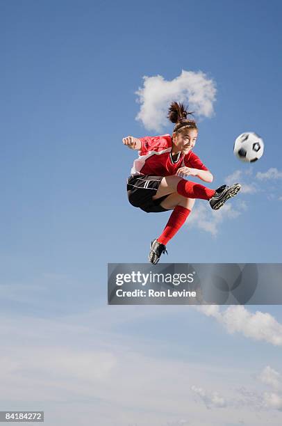 girl kicking soccer ball, airborne - girl kicking stock pictures, royalty-free photos & images