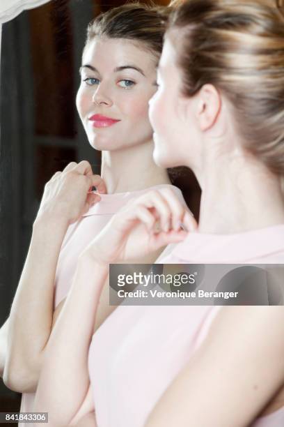 woman looking at herself in a mirror. - pink vanity stock pictures, royalty-free photos & images
