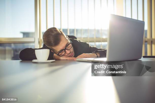 tired young businessman in the office - economic crisis stock pictures, royalty-free photos & images