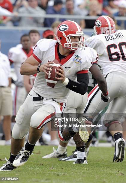 Quarterback Matthew Stafford of the University of Georgia looks to pass against the Michigan State Spartans at the 2009 Capital One Bowl at the...