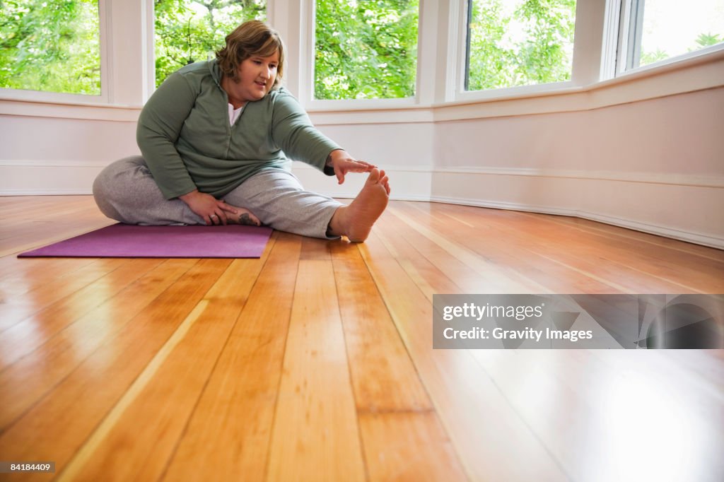 Woman Stretching on Living Room Floor