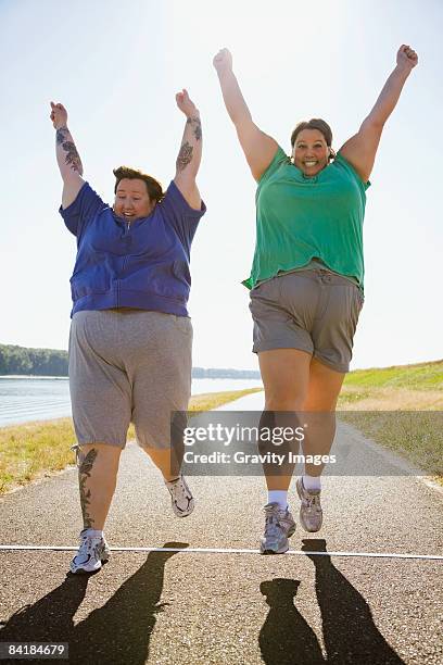 women running across finish line - close to finish line stock pictures, royalty-free photos & images