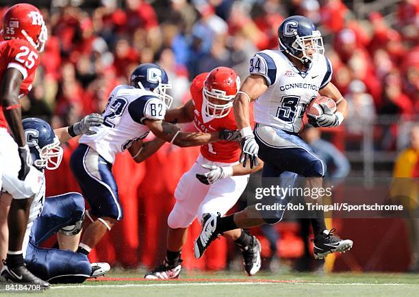 Running back Donald Brown of the Connecticut Huskies rushes against the Rutgers Scarlet Knights at Rutgers Stadium on October 18, 2008 in Piscataway,...