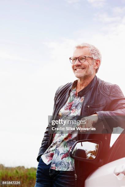 portrait of a mature adult man taking a break from driving - homem bonito imagens e fotografias de stock