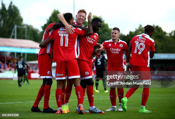 Jordan Roberts of Crawley Town celebrates with his teammates after scoring his sides first goal during the Sky Bet League Two match between Crawley...