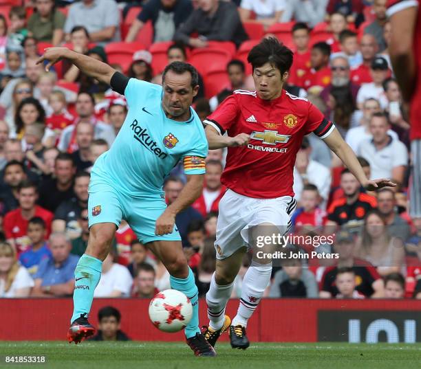 Ji-Sung Park of Manchester United Legends in action with Sergi Barjuan of Barcelona Legends during the MU Foundation charity match between Manchester...