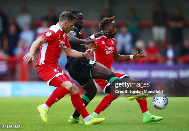 Dannie Bulman and Cedric Evina of Crawley Town tackle with Olufela Olomola of Yeovil Town during the Sky Bet League Two match between Crawley Town...