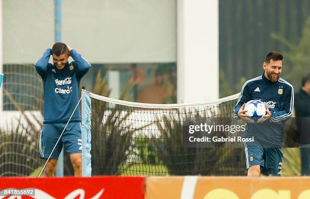 Mauro Icardi and Lionel Messi of Argentina smile during a training session at 'Julio Humberto Grondona' training camp on September 02, 2017 in...