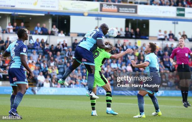 Adebayo Akinfenwa of Wycombe Wanderers battles for the ball with Christian Doidge of Forest Green Rovers during the Sky Bet League Two match between...