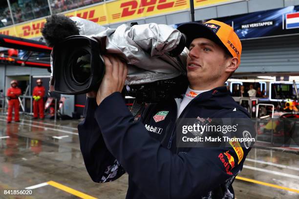 Max Verstappen of Netherlands and Red Bull Racing uses a TV camera in the Pitlane during qualifying for the Formula One Grand Prix of Italy at...