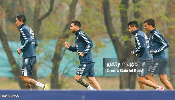 Angel Di Maria , Lionel Messi and Paulo Dybala of Argentina warm up during a training session at 'Julio Humberto Grondona' training camp on September...