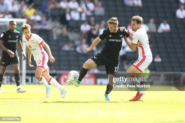 James Henry of Oxford United attempts to control the ball under pressure from Ed Upson of Milton Keynes Dons during the Sky Bet League One match...