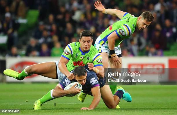 Will Chambers of the Storm is tackled during the round 26 NRL match between the Melbourne Storm and the Canberra Raiders at AAMI Park on September 2,...