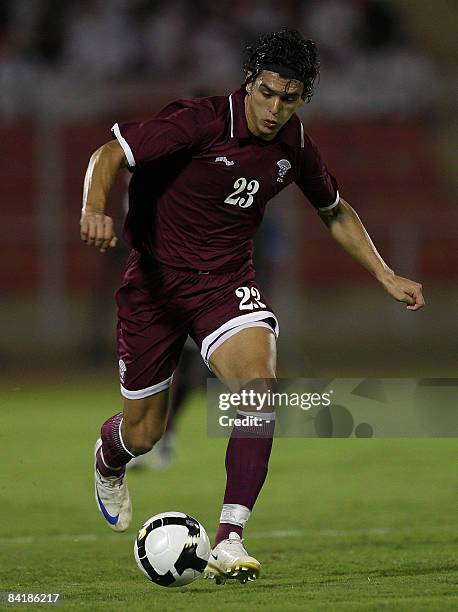 Qatar's player Sebastian Soria runs with the ball during his team's football match against Saudi on the second day of the 19th Gulf Cup in Muscat on...