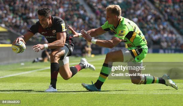 Sean Maitland of Saracens, despite being tackled by Harry Mallinder, scores his first try of a first half hatrick during the Aviva Premiership match...