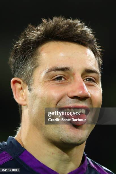 Cooper Cronk of the Storm reacts as he watches a highlights package on the big screen after he played his final home match after the round 26 NRL...