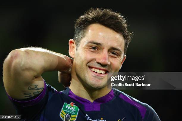 Cooper Cronk of the Storm reacts as he watches a highlights package on the big screen after he played his final home match after the round 26 NRL...