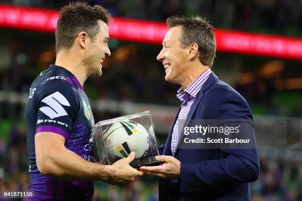 Storm coach Craig Bellamy presents Cooper Cronk of the Storm with the match ball after Cronk played his final home match after the round 26 NRL match...