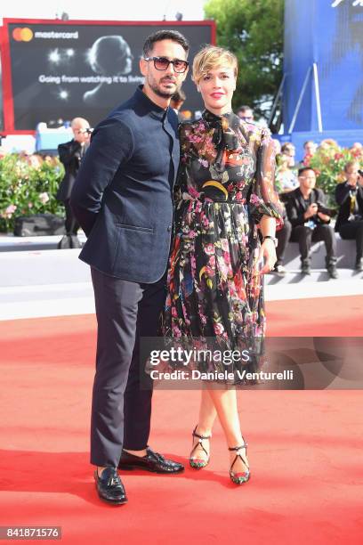 Riccardo Pasquale and Roberta Giarrusso walk the red carpet ahead of the 'Foxtrot' screening during the 74th Venice Film Festival at Sala Grande on...