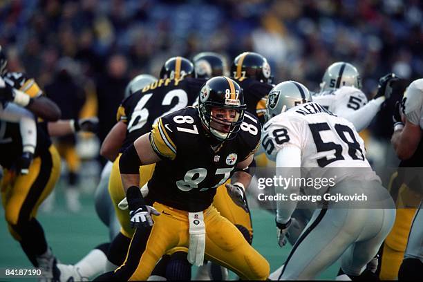 Tight end Mark Bruener of the Pittsburgh Steelers blocks against linebacker Elijah Alexander of the Oakland Raiders at Three Rivers Stadium on...