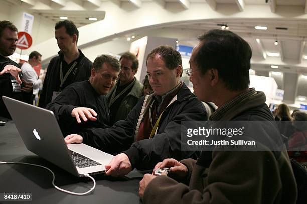 MacWorld attendees look at a display model of the new MacBook Pro 17 inch laptops during the MacWorld Conference January 6, 2009 at the Moscone...