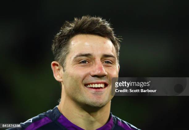 Cooper Cronk of the Storm reacts as he watches a highlights package on the big screen after he played his final home match after the round 26 NRL...