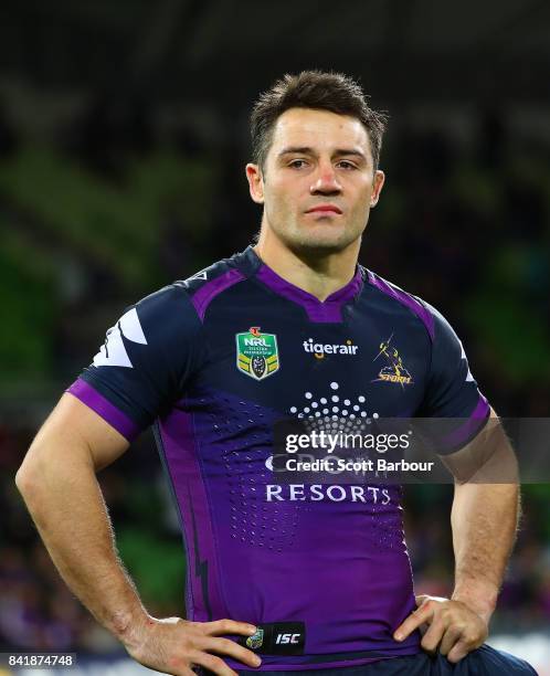 Cooper Cronk of the Storm reacts as he watches a highlights package on the big screen after he played his final home match after the round 26 NRL...