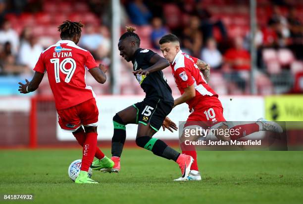 Jordan Green of Yeovil Town tackles with Dean Cox and Cedric Evina of Crawley Town during the Sky Bet League Two match between Crawley Town and...