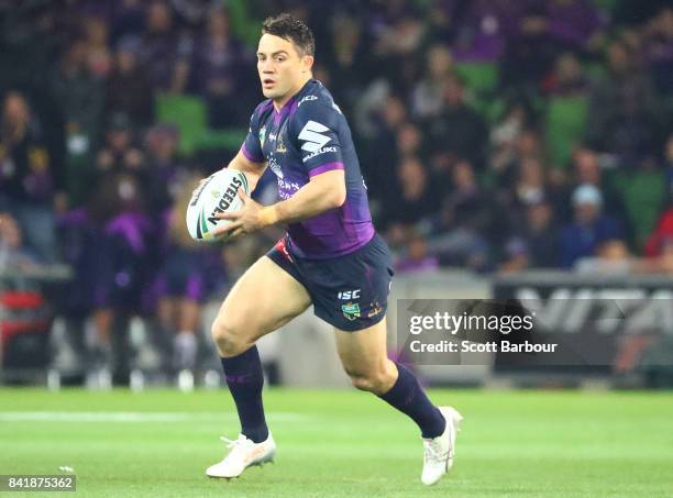 Cooper Cronk of the Storm runs with the ball during the round 26 NRL match between the Melbourne Storm and the Canberra Raiders at AAMI Park on...