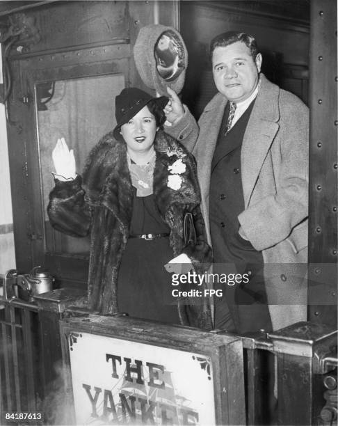 American baseball player Babe Ruth and his wife Claire wave from the train they rode to Boston after the Babe was sold by the Yankees, New York, New...