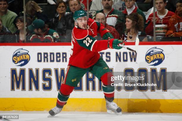 Cal Clutterbuck of the Minnesota Wild clears the puck against the San Jose Sharks during the game at the Xcel Energy Center on December 31, 2008 in...